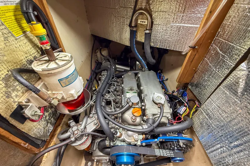 Slide: The Image of Engine compartment of a 2004 Island Packet 370 sailboat, showcasing detailed mechanical components. - 35