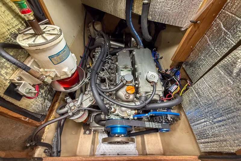 Slide: The Image of Engine compartment of a 2004 Island Packet 370 sailboat, showcasing detailed mechanical components. - 34