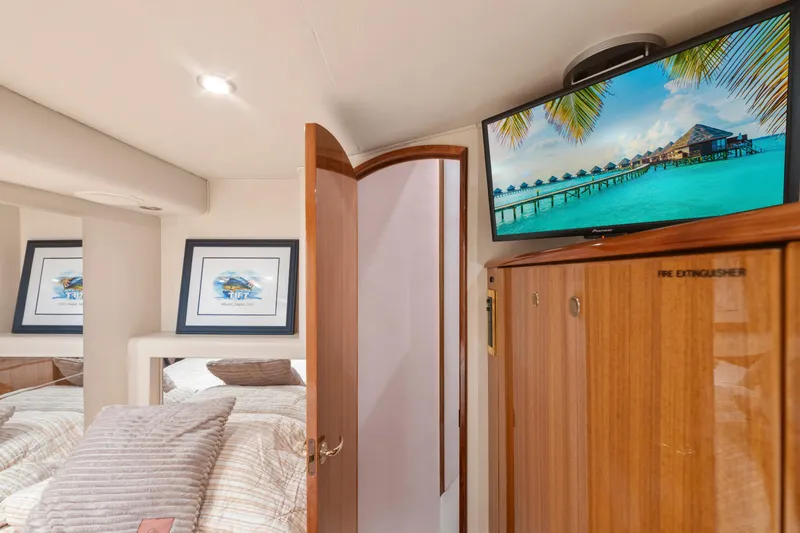 Slide: The Image of Interior of 2006 Viking 68 Convertible yacht with cozy bedroom and mounted TV. - 37
