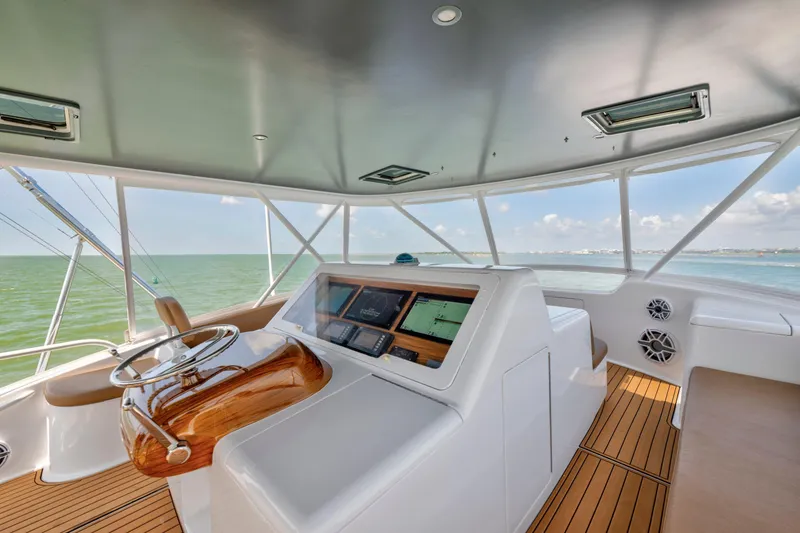 Slide: The Image of Helm of 2006 Viking 68 Convertible yacht with ocean view and modern controls. - 7