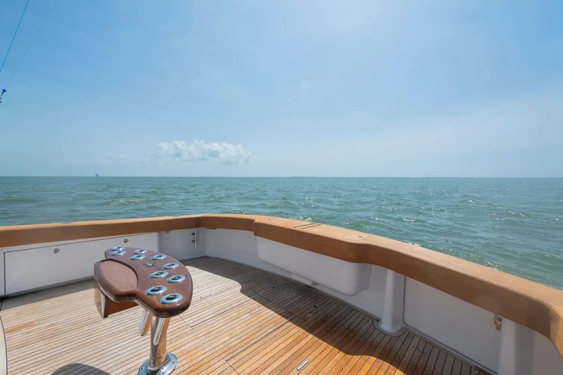 Slide: The Image of 2006 Viking 68 Convertible yacht deck overlooking the ocean under a clear blue sky. - 19