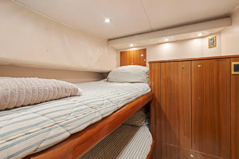 Slide: The Image of Cozy cabin interior of 2006 Viking 68 Convertible yacht with wooden bunk beds. - 40