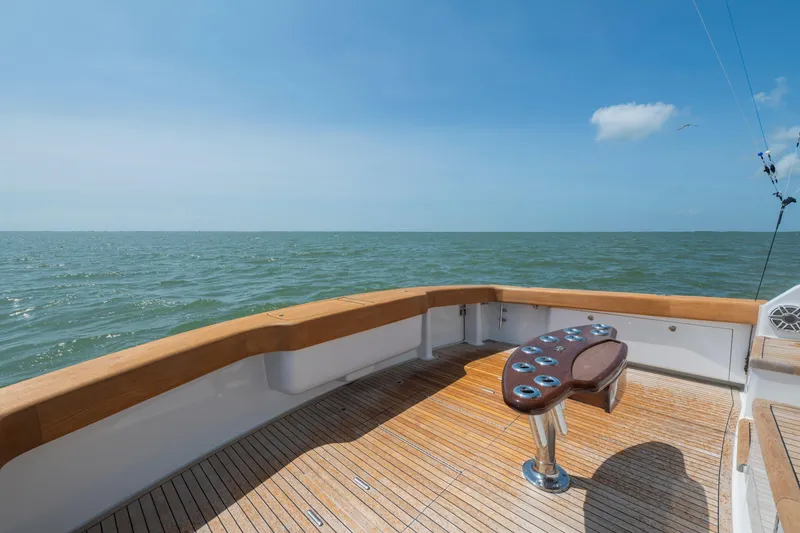 Slide: The Image of Viking 68 Convertible 2006 yacht deck overlooking the ocean under a clear blue sky. - 18