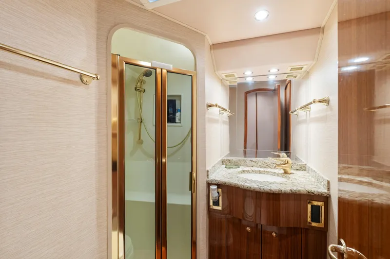 Slide: The Image of Luxurious bathroom in 2006 Viking 68 Convertible yacht with granite countertop and glass shower. - 42
