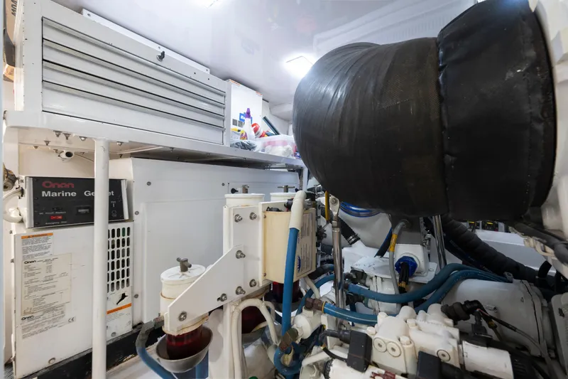 Slide: The Image of Engine room of a 2006 Viking 68 Convertible yacht, featuring Onan marine generator. - 51