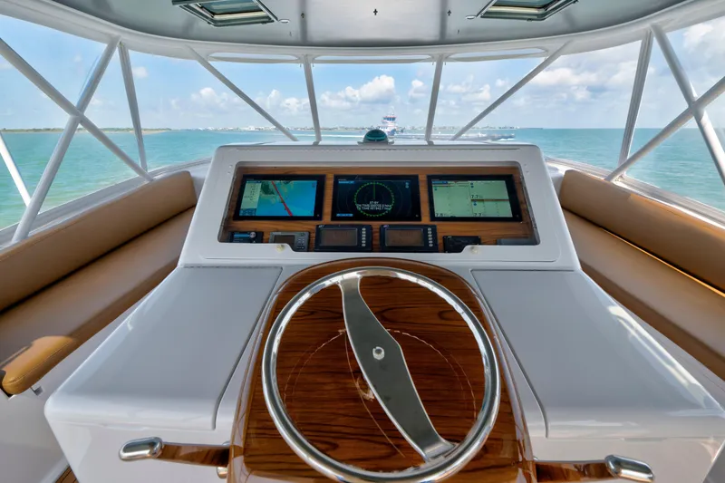 Slide: The Image of Helm of 2006 Viking 68 Convertible yacht with navigation screens and wooden steering wheel. - 5