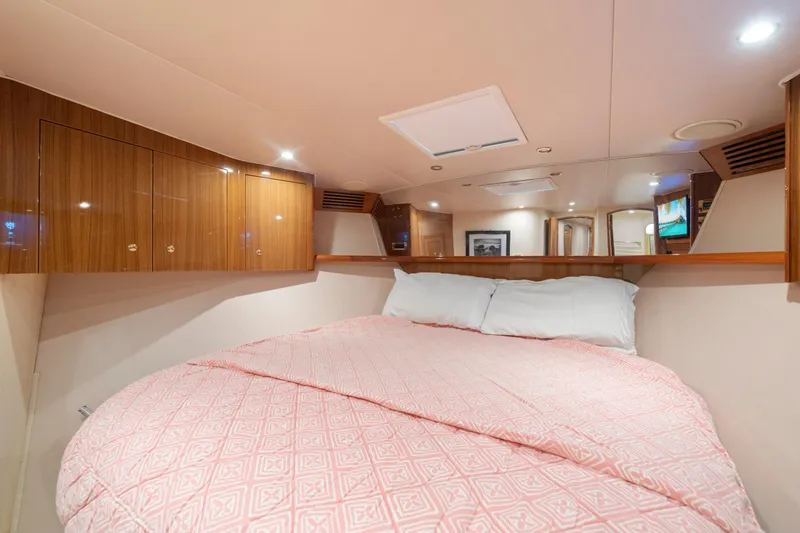 Slide: The Image of Luxurious cabin interior of 2006 Viking 68 Convertible yacht with cozy bed and wooden cabinets. - 44