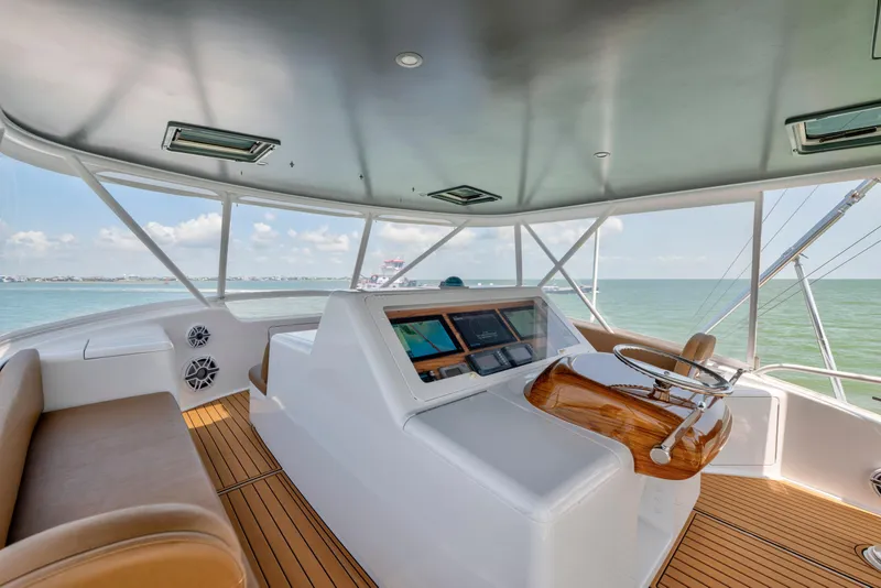Slide: The Image of Interior view of 2006 Viking 68 Convertible yacht helm with ocean backdrop. - 6
