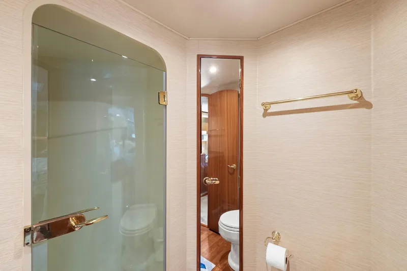 Slide: The Image of Bathroom interior of 2006 Viking 68 Convertible yacht with glass shower and wooden door. - 35
