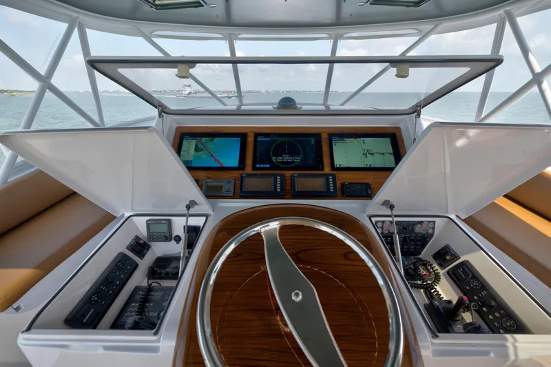 Slide: The Image of Helm of 2006 Viking 68 Convertible yacht with navigation screens and controls. - 8