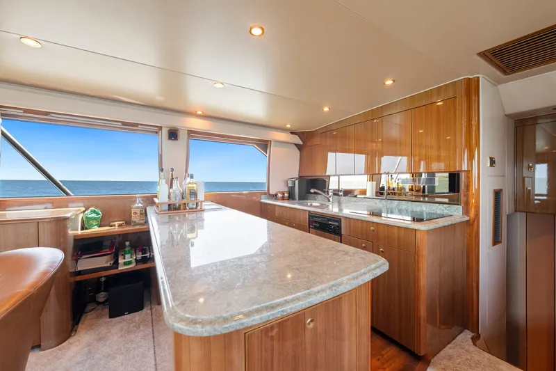 Slide: The Image of Luxurious interior of a 2006 Viking 68 Convertible yacht with modern kitchen and ocean view. - 27