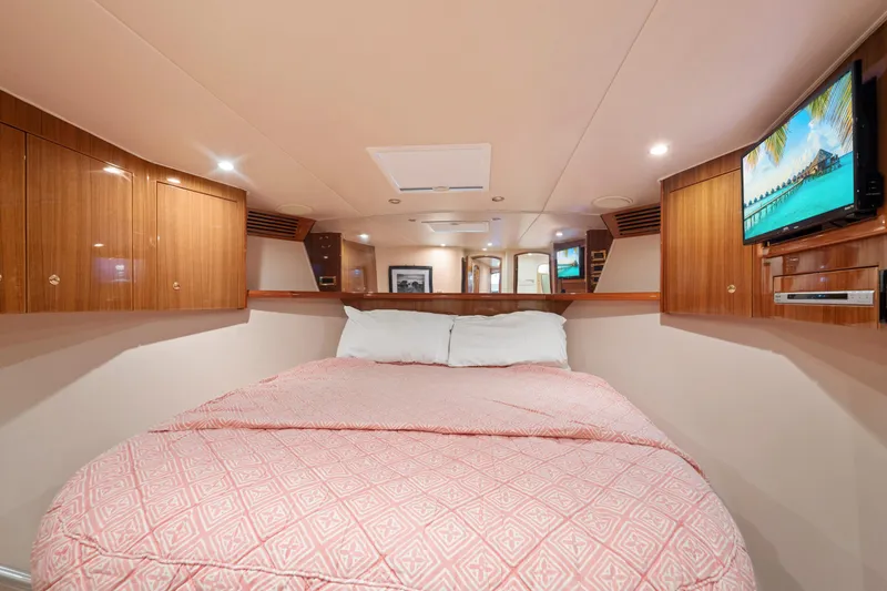 Slide: The Image of Luxurious cabin interior of 2006 Viking 68 Convertible yacht with cozy bedding and wood cabinetry. - 43