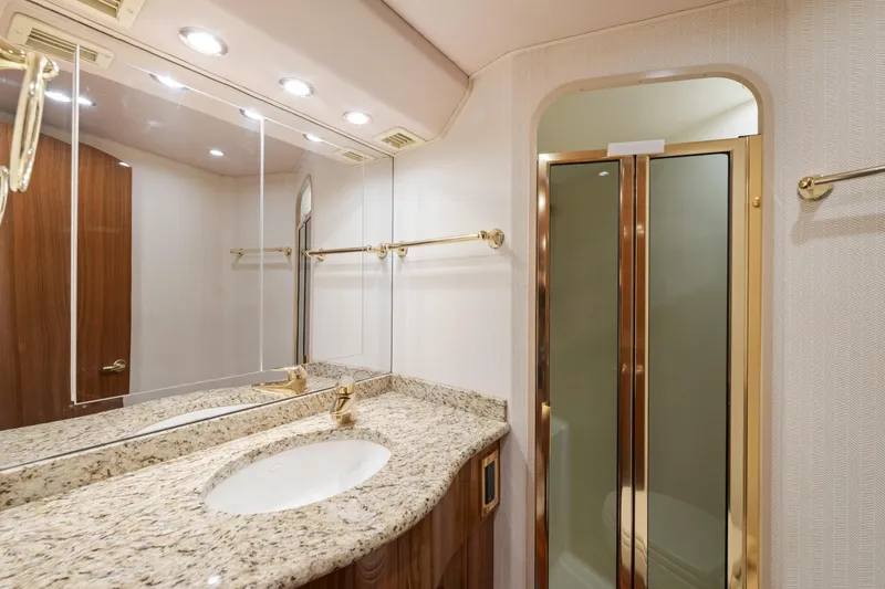 Slide: The Image of Luxurious bathroom in 2006 Viking 68 Convertible yacht with granite countertop and glass shower. - 45