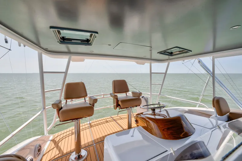 Slide: The Image of Flybridge of 2006 Viking 68 Convertible yacht with ocean view and seating. - 12