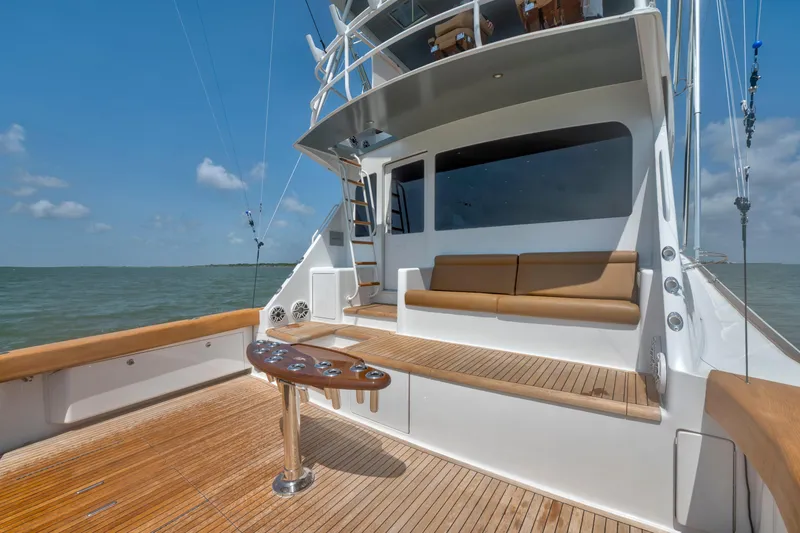 Slide: The Image of 2006 Viking 68 Convertible yacht deck with seating, ocean view, and fishing rod holders. - 16