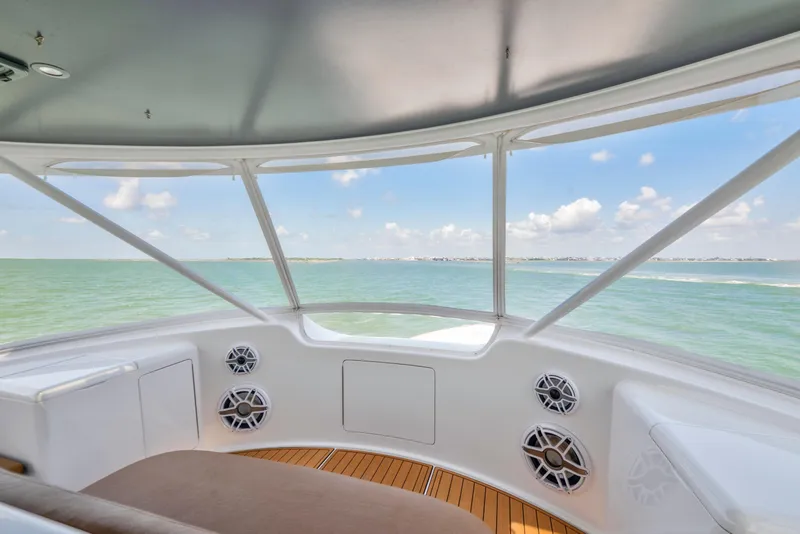 Slide: The Image of Interior view from a 2006 Viking 68 Convertible yacht, overlooking serene ocean waters. - 14