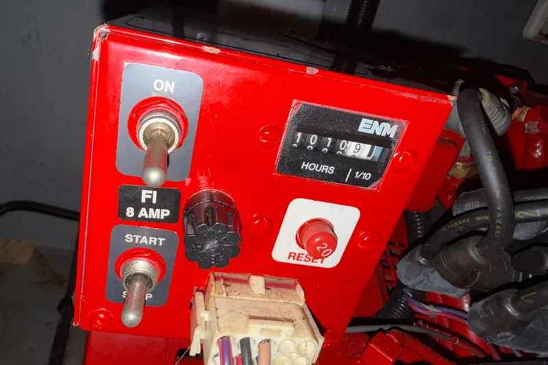 Slide: The Image of Control panel of a 1999 Sea Ray 380 Sundancer with hour meter and switches. - 22