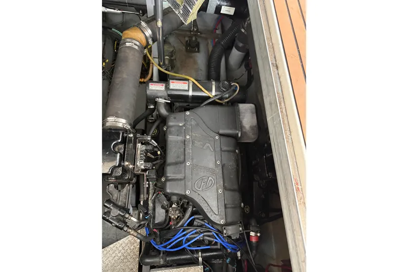 Slide: The Image of Engine compartment of a 1999 Sea Ray 380 Sundancer boat, showcasing mechanical components. - 24