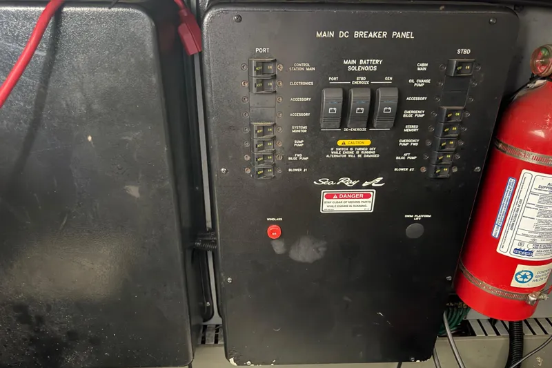 Slide: The Image of Main DC breaker panel of 1999 Sea Ray 380 Sundancer with fire extinguisher. - 21