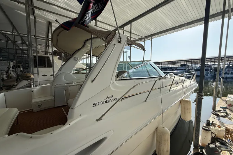 Slide: The Image of 1999 Sea Ray 380 Sundancer docked in a marina under a covered slip. - 4