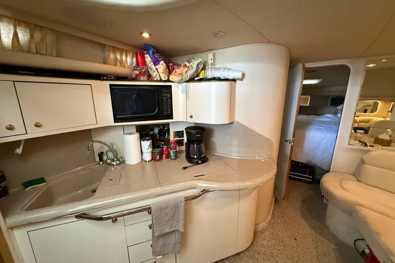 Slide: The Image of Interior of 1999 Sea Ray 380 Sundancer yacht kitchen with sink, microwave, and coffee maker. - 14