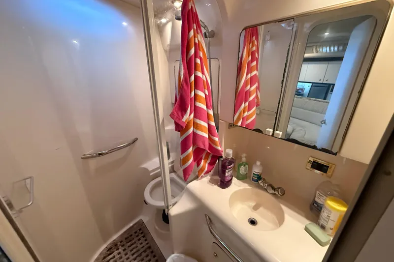 Slide: The Image of Bathroom interior of 1999 Sea Ray 380 Sundancer yacht with sink, mirror, and shower. - 15