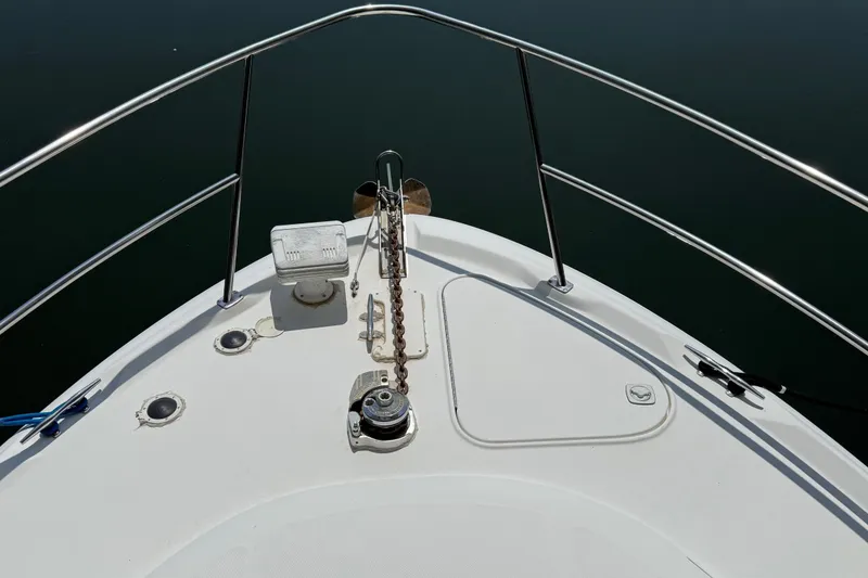 Slide: The Image of Bow of 1999 Sea Ray 380 Sundancer with anchor chain and railing. - 11