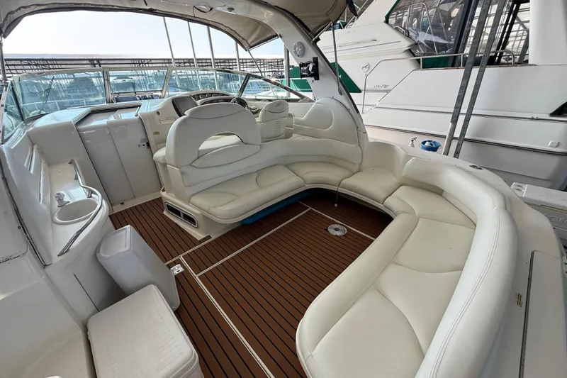 Slide: The Image of 1999 Sea Ray 380 Sundancer yacht interior with white seating and wooden flooring. - 5