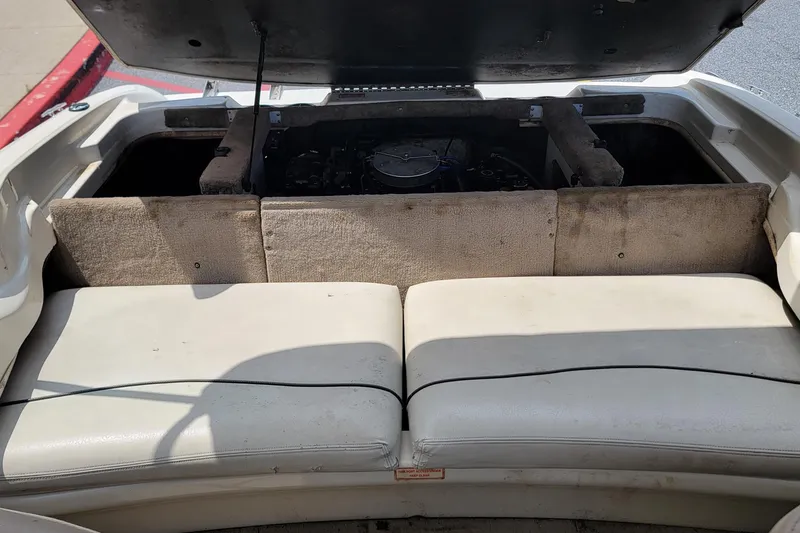 Slide: The Image of 2003 Sea Ray 182 Bow Rider engine compartment with open cover and seating area. - 8
