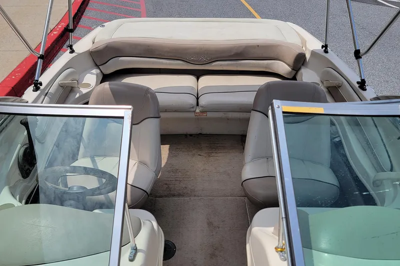 Slide: The Image of 2003 Sea Ray 182 Bow Rider interior with beige seating and windshield view. - 14