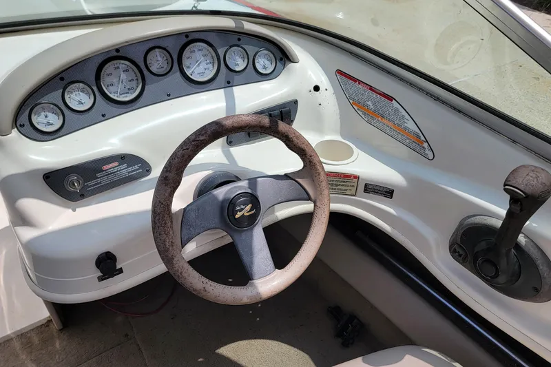 Slide: The Image of 2003 Sea Ray 182 Bow Rider dashboard with steering wheel and instrument panel. - 12