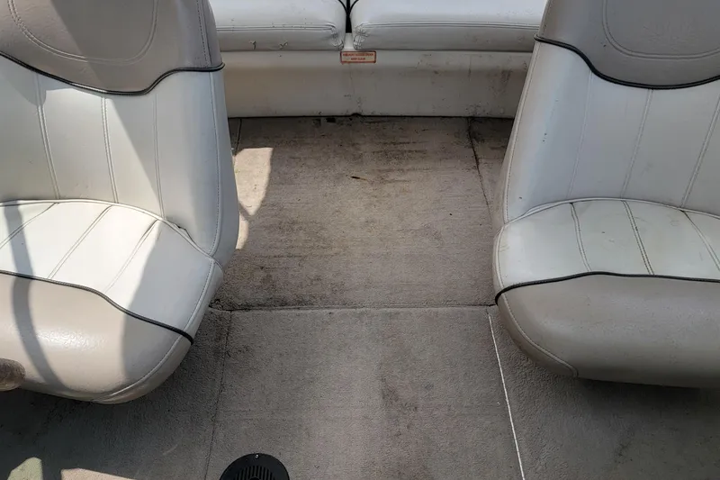 Slide: The Image of Interior of a 2003 Sea Ray 182 Bow Rider with white seating and carpeted floor. - 15