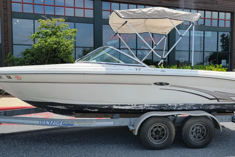Slide: The Image of 2003 Sea Ray 182 Bow Rider boat on trailer, parked outdoors. - 16