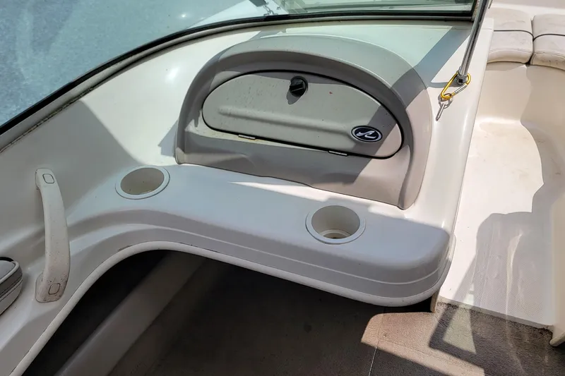 Slide: The Image of Interior view of a 2003 Sea Ray 182 Bow Rider boat with cup holders and storage compartment. - 13