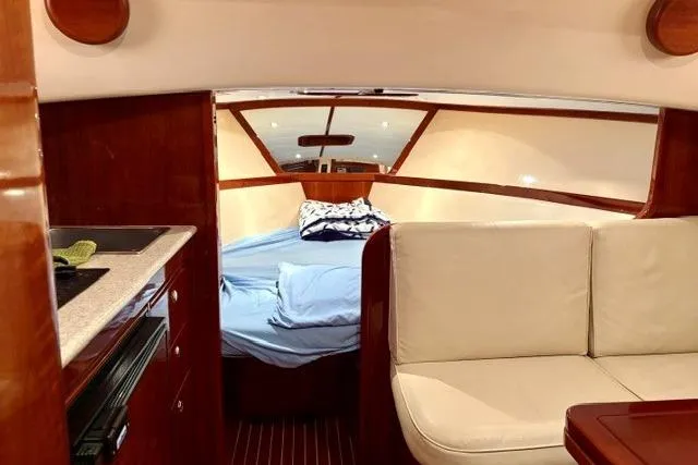 Slide: The Image of Interior of 2001 Apreamare 9 M yacht with cozy cabin and seating area. - 14