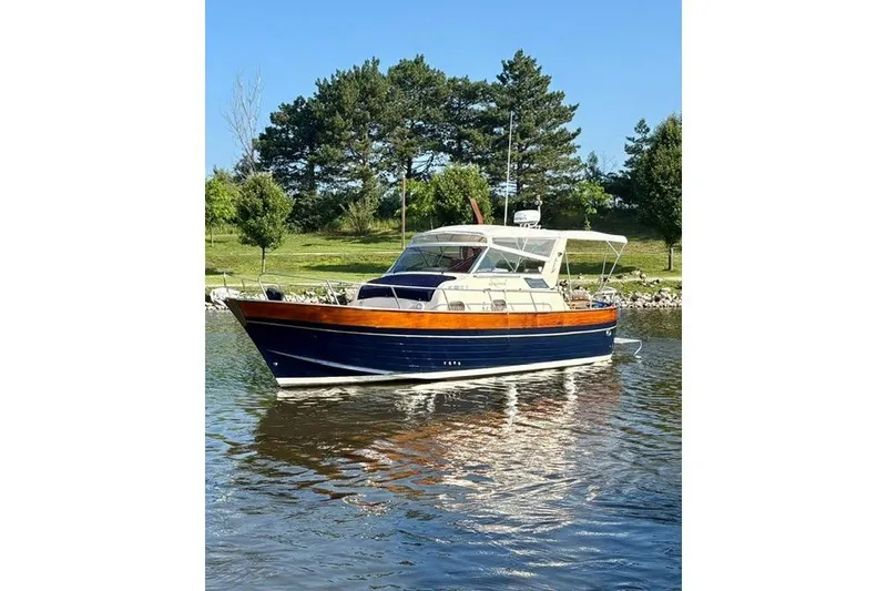 Slide: The Image of 2001 Apreamare 9 M boat on calm water, surrounded by lush greenery. - 30
