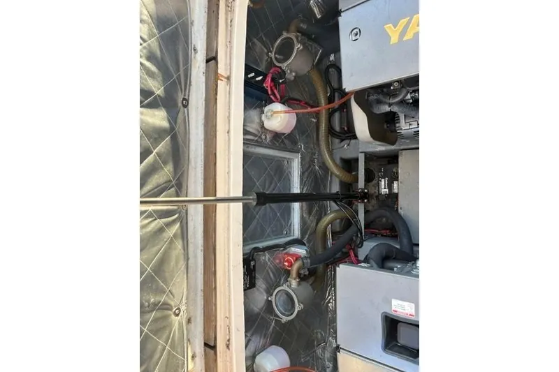 Slide: The Image of Engine compartment of a 2001 Apreamare 9 M boat, showcasing mechanical components and wiring. - 23