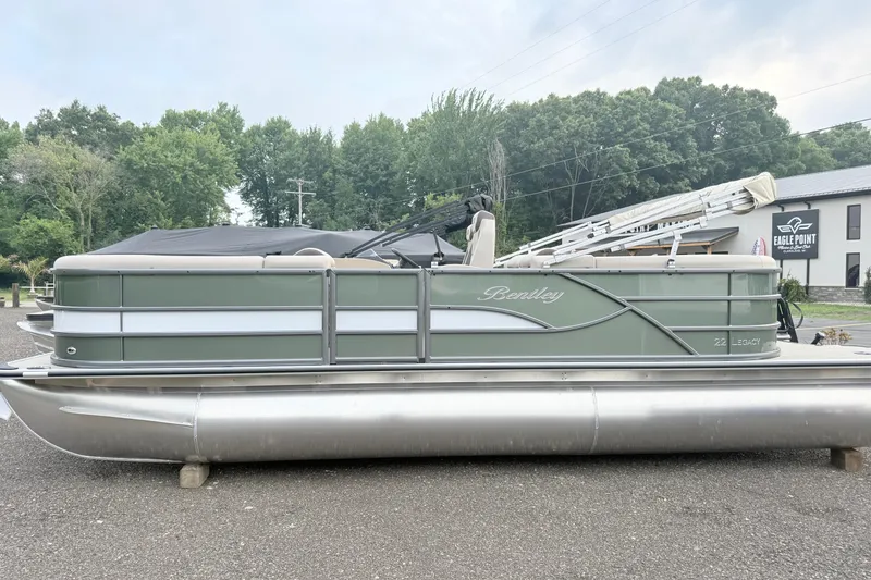 The Image of 2027 Bentley Pontoons Legacy 220 Navigator in a serene outdoor setting. - 1