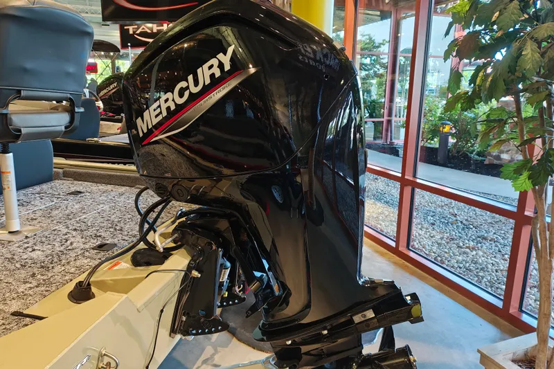 Slide: The Image of 2026 Tracker Pro Team 175 boat with Mercury outboard motor in showroom. - 4
