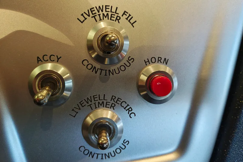Slide: The Image of Control panel of 2026 Tracker Pro Team 175 boat with switches and horn button. - 15