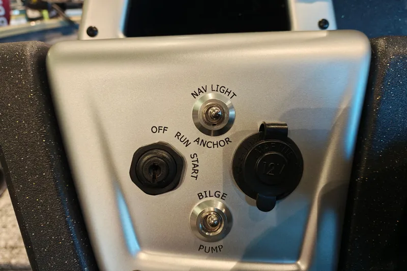 Slide: The Image of Control panel of 2026 Tracker Pro Team 175 boat with switches and 12V outlet. - 16