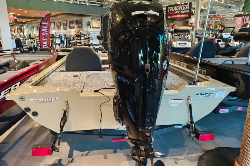 Slide: The Image of 2026 Tracker Pro Team 175 boat with powerful outboard motor in showroom display. - 6