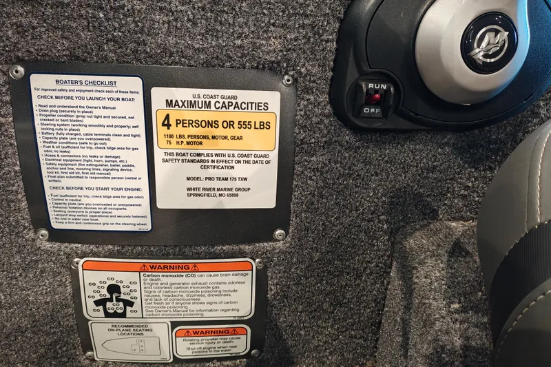 Slide: The Image of Tracker Pro Team 175 boat capacity and safety labels, 2026 model, with engine control switch. - 17