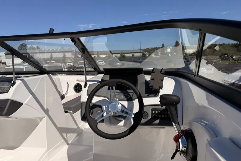 Slide: The Image of 2024 Tahoe 210 S boat cockpit with steering wheel and control panel. - 6