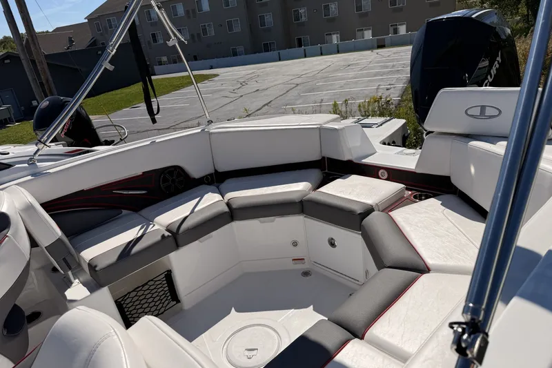 Slide: The Image of 2024 Tahoe 210 S boat interior with white and gray seating in a parking lot. - 5