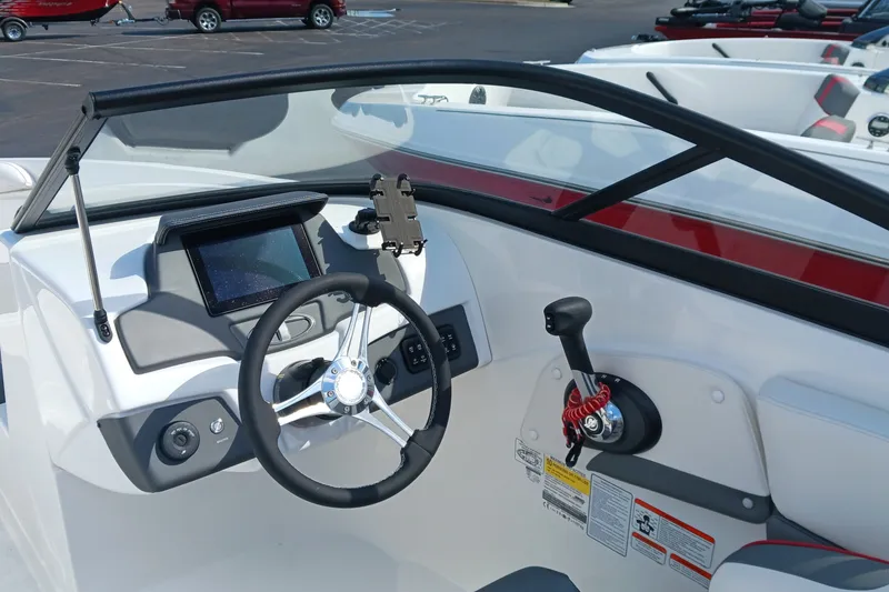 Slide: The Image of 2024 Tahoe 210 S boat dashboard with steering wheel and control panel. - 10