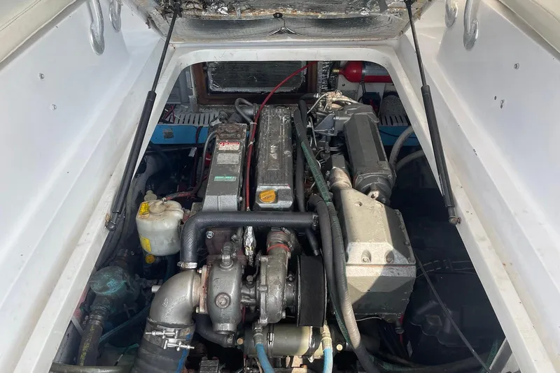 Slide: The Image of Engine compartment of a 1999 Mainship Pilot 30 boat, showcasing mechanical components. - 21
