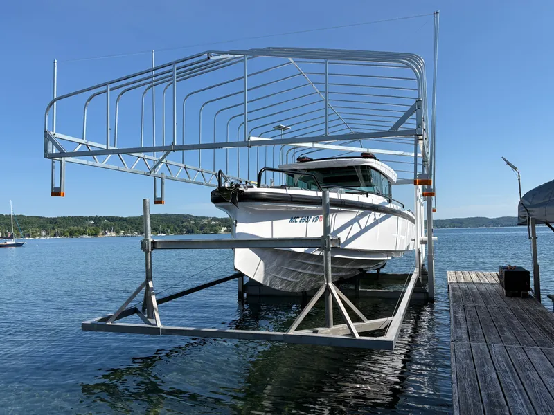 Slide: The Image of A 2024 Axopar 37 XC Cross Cabin boat on a boat lift at the dock. - 22
