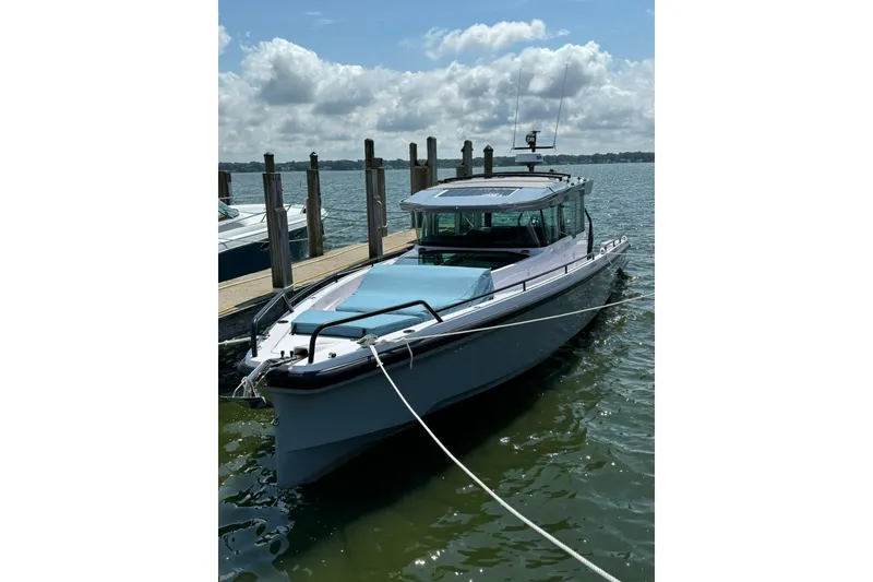 Slide: The Image of 2024 Axopar 37 XC Cross Cabin boat docked on a sunny day. - 31