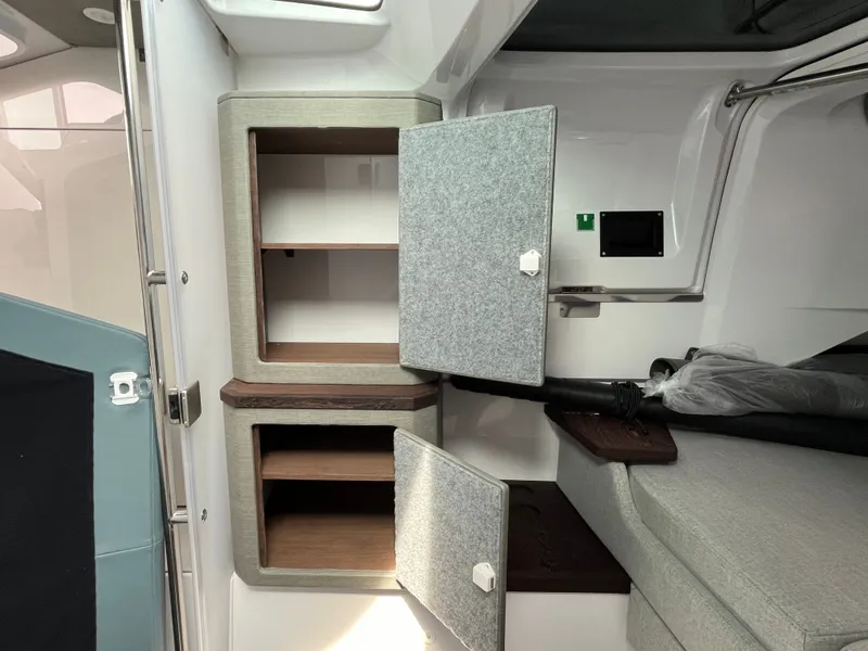 Slide: The Image of Interior of the 2024 Axopar 37 XC Cross Cabin with gray cabinets and seating area. - 20